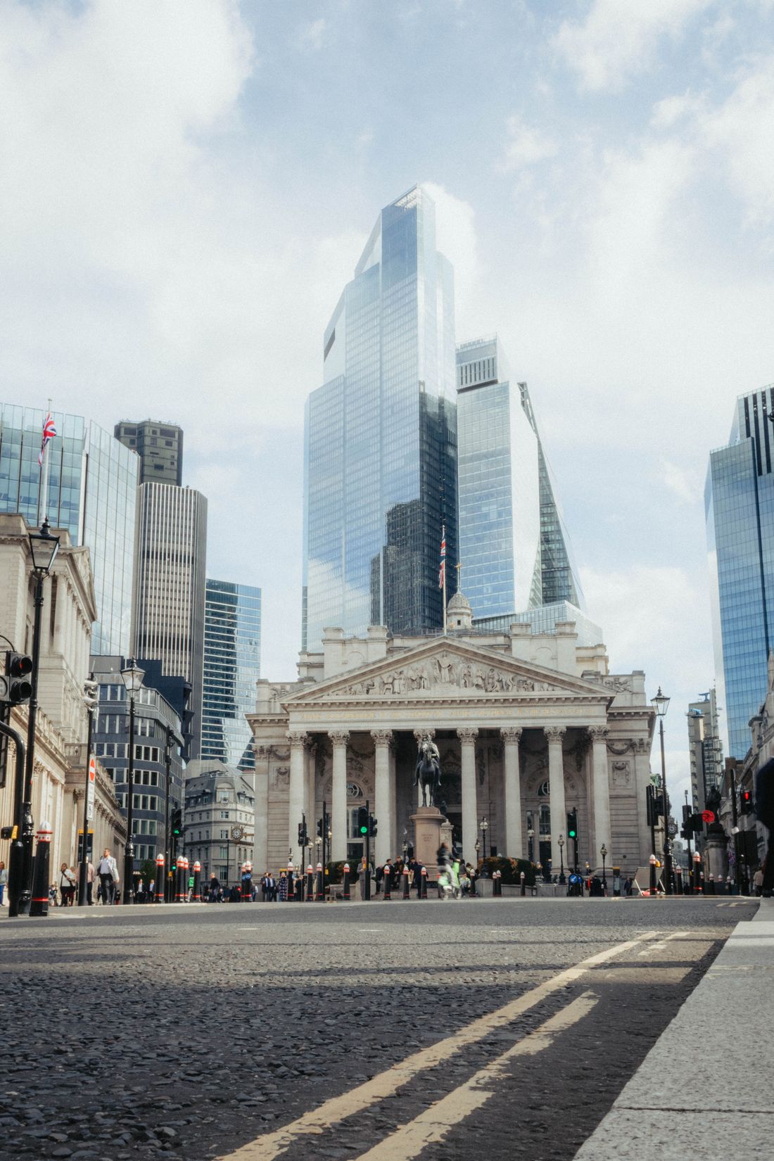 The historic Royal Exchange colonnade set against the modern towers of the City of London